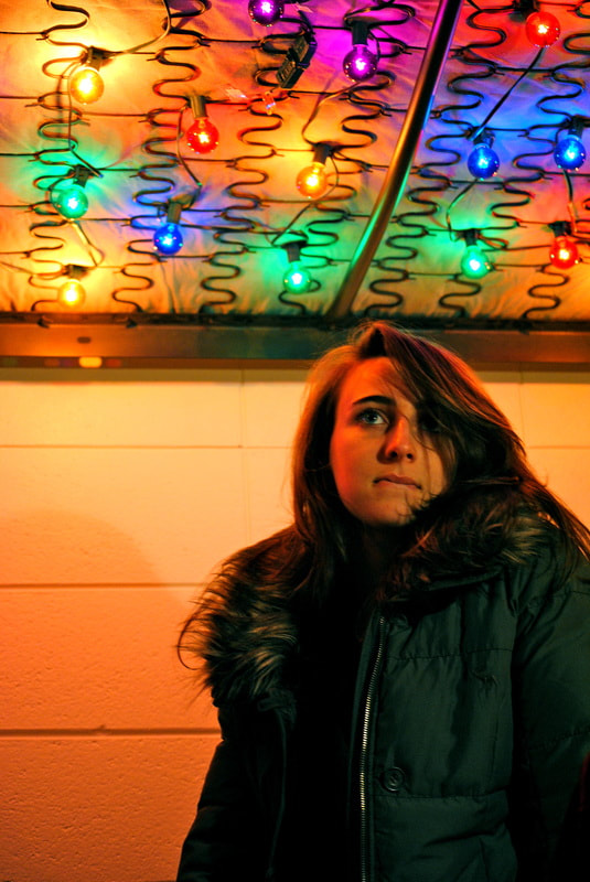 Portrait of woman under colorful lights (Digital)