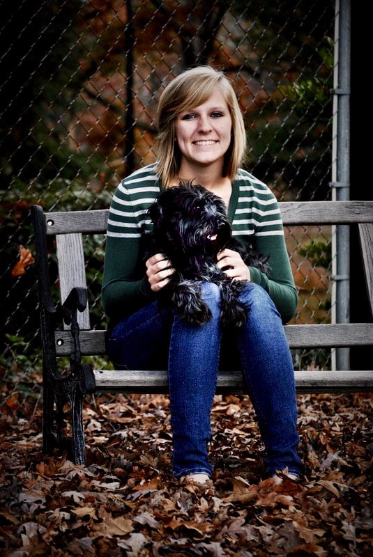 Portrait of woman on bench holding dog (Digital)